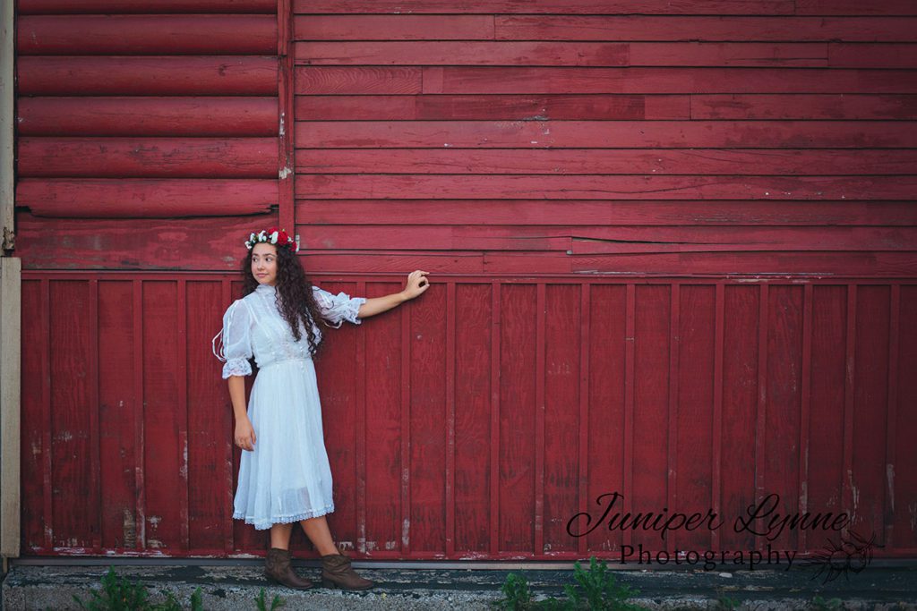 High school senior girl in red and white flower crown downtown Poulsbo Washington nordic look what to wear boho with Juniper Lynne Photography of Gig Harbor