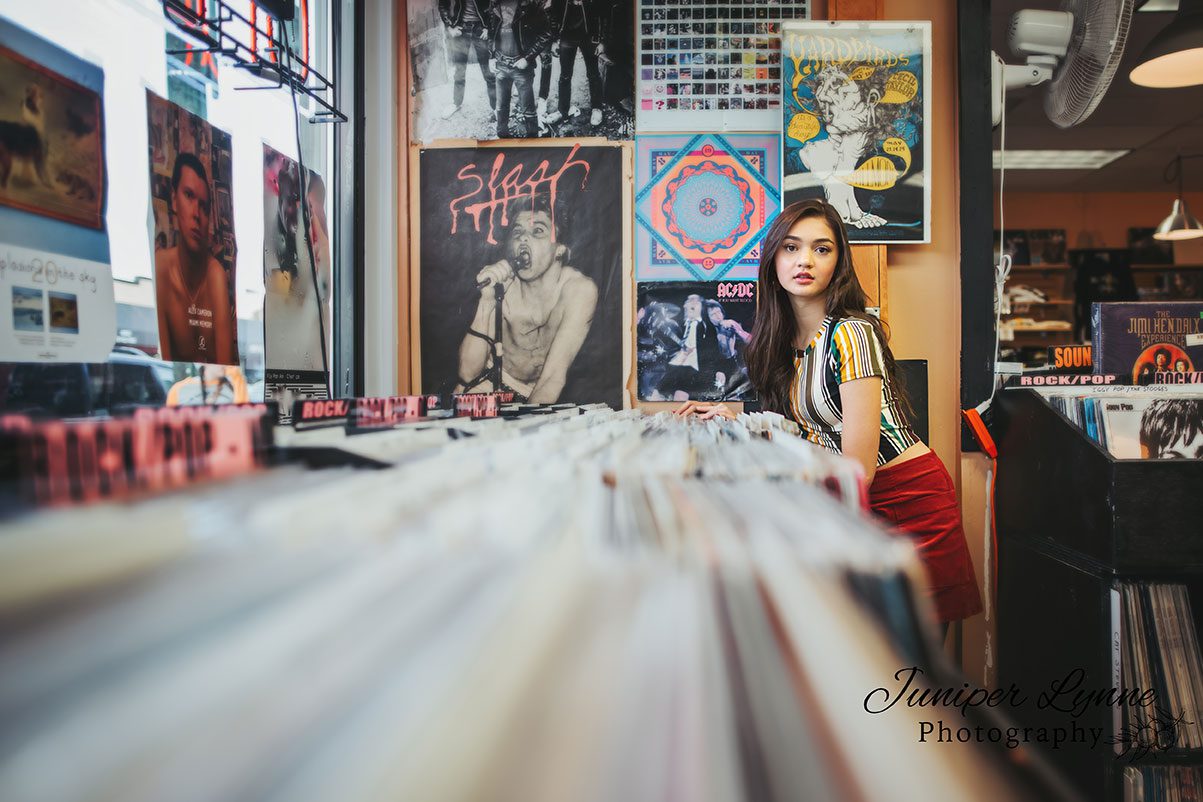 Teen girl in record store on 6th ave in Tacoma Washington Model Rep program for Juniper Lynne Photography of Gig Harbor