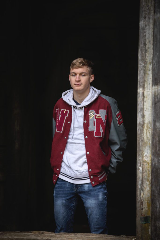 class of 2020 high school senior guy style letterman's jacket at manchester state park in Port Orchard by Juniper Lynne Photography.