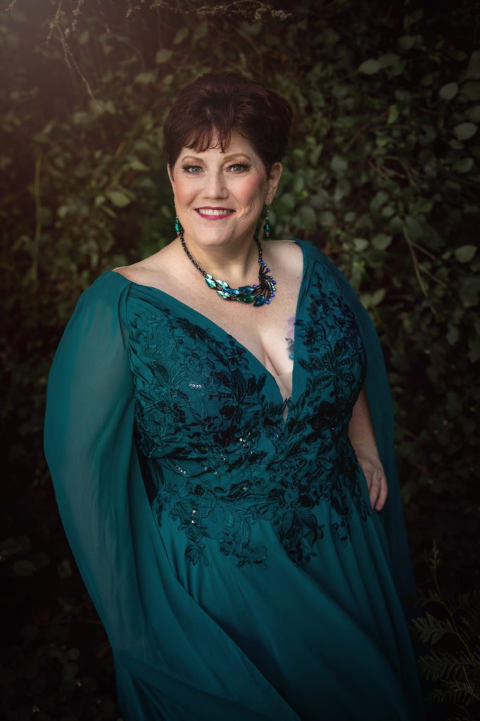 joyfully aging plus size women in her 50s with gown in woods western washington state