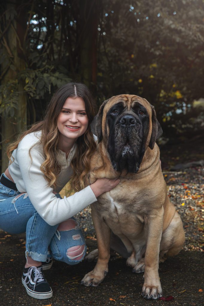 high school senior girl in jeans and white shirt with her dog outside in Western Washington State by Juniper Lynne Photography