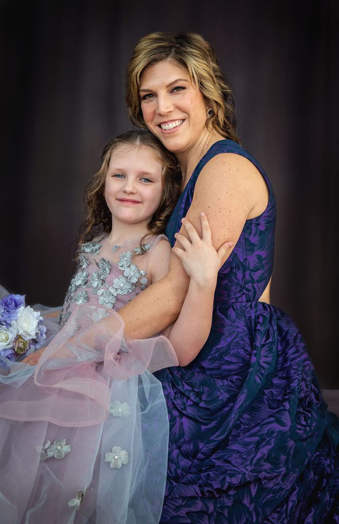 mother with daughter in couture princess dress in studio setting 